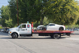 A tow truck hauling a car involved in an accident in Arvada, Colorado.